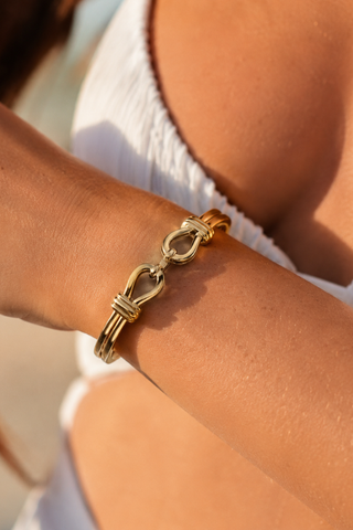 Abby Knot Bracelet in gold, worn on the wrist showing the double looped knot detail