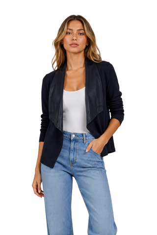 Veronica Jacket in navy, front view with open draped lapel, worn over a white tank and light jeans