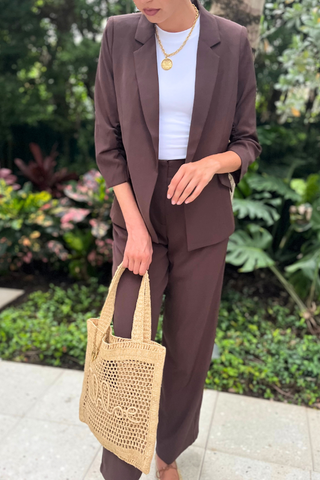 Recycled Shirred Blazer in chocolate brown, worn open over a white tee, holding a raffia tote