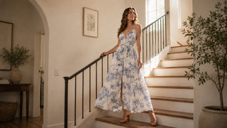 Woman in a blue and white floral maxi dress on a staircase