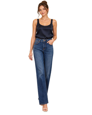 The Elina Silk Top – in dark navy, front view on model, worn with jeans