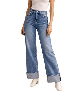 Evelyn Straight Cuffed Jeans in medium blue wash, front view from the waist down, worn with white boots