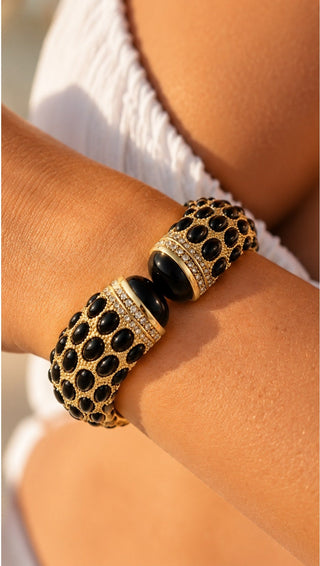 Cleo Studded Cuff Bracelet worn on the wrist, showing black stones and crystal ends against a white top
