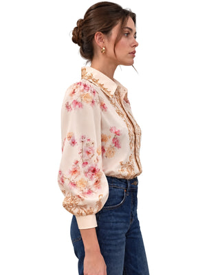 Zim Top in light pink, three-quarter side view with gold-trimmed collar and button placket