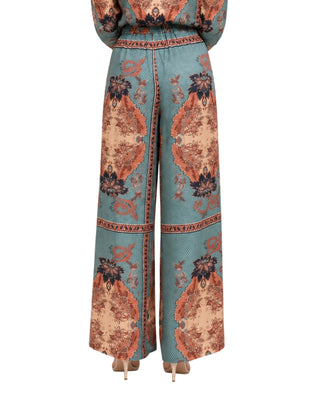 Emmy Paisley Print Wide Leg Pants in multi, back view with rust medallion print on each leg