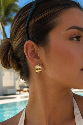 Estelle Gold Chunky Hoop Earrings, worn on the ear in close-up, poolside